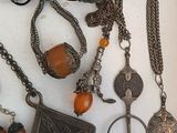 a lot of necklaces that are on a table