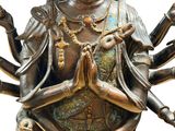 bronze statue of a woman with four arms and hands in the air