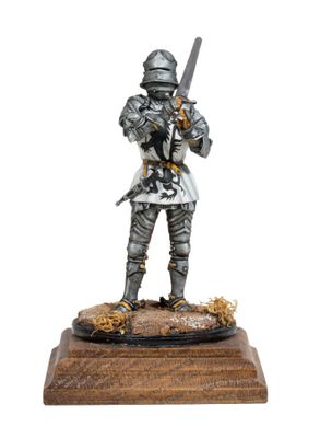 statue of a knight in full armor holding a sword on a wooden base