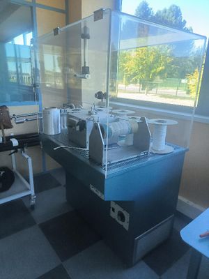 a coffee machine that is sitting on a table in front of a window