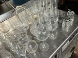 many empty wine glasses on a table in the kitchen