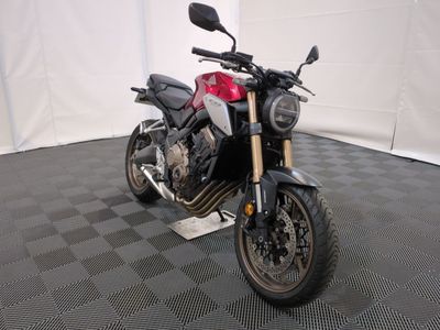 a motorcycle that is parked on a black and white checkered floor