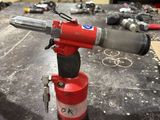 a red fire extinguisor sitting on a table in a workshop