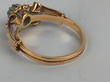 an image of a gold ring with a purple stone