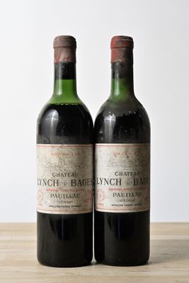 two bottles of wine sitting on top of a table next to each other