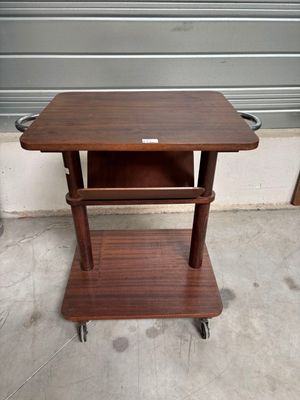 a small wooden table with a shelf on top of it