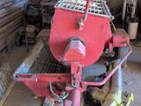 a red machine that is sitting in a garage
