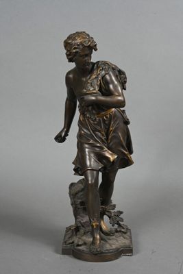 bronze statue of a boy with a bird on his shoulder