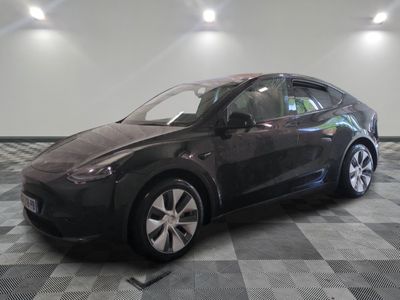 an image of a black tesla vehicle in a showroom