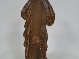 an old statue of a man standing on a white surface