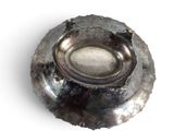a silver plate on a white surface with a hole in the middle
