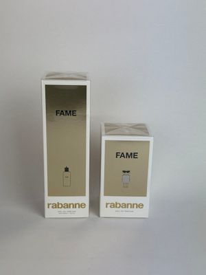 two boxes of perfume sitting next to each other on a white surface