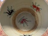 a bowl that has a bird design on the inside of it