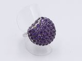 an image of a ring with purple stones on a clear base