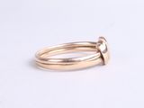 a close up of a gold ring on a white surface