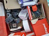 a cardboard box full of assorted electronics and other items