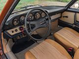 a dashboard and steering wheel of a car with tan leather seats