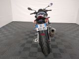 a motorcycle that is parked in a room with a checkered floor