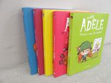 four children ' s books are lined up in a row on a couch