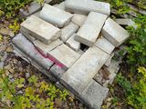 a pile of bricks sitting on the ground in the grass