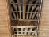 a wooden sauna that is in the corner of the room
