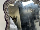 a mirror that is sitting on a table in front of a mirror
