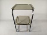 an image of a glass table with a metal base and a glass top