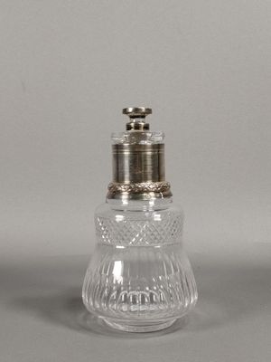 an antique glass salt and pepper shaker with a silver top