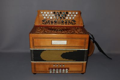an image of an old accordion sitting on top of a table