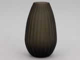 a black and brown vase sitting on a white surface