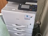 a printer that is sitting on top of a cabinet