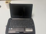 a laptop computer sitting on top of a white table