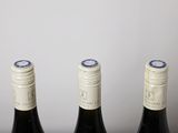 three bottles of wine that are sitting on a table