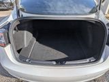 the back of a car with its trunk open in a parking lot