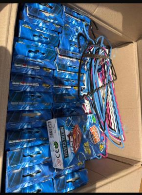 a cardboard box full of blue soda bottles and a bunch of other sodas