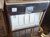 an image of a small refrigerator in the corner of a room