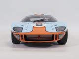 an orange and blue model of a race car on a white surface