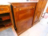a wooden cabinet with drawers and a drawer underneath it