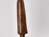 wooden sculpture of a man with a hat and coat on a wooden base