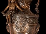 a statue of a woman sitting on top of a vase