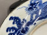 a blue and white plate with a dragon on it