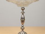 an image of a silver plate on a wooden table with a gray background