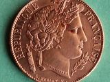 a close up of a coin on a green surface