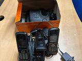 three cell phones in a box on a table