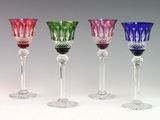 several different colored wine glasses are lined up in a row