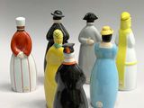 five figurines of people in different colors and sizes