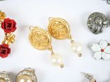 many different types of jewelry displayed on a white surface