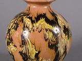 a vase that has a brown and black design on it