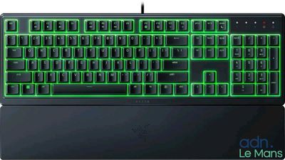 a close up of a keyboard with green lights on it