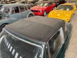 many old cars parked in a garage with a lot of them